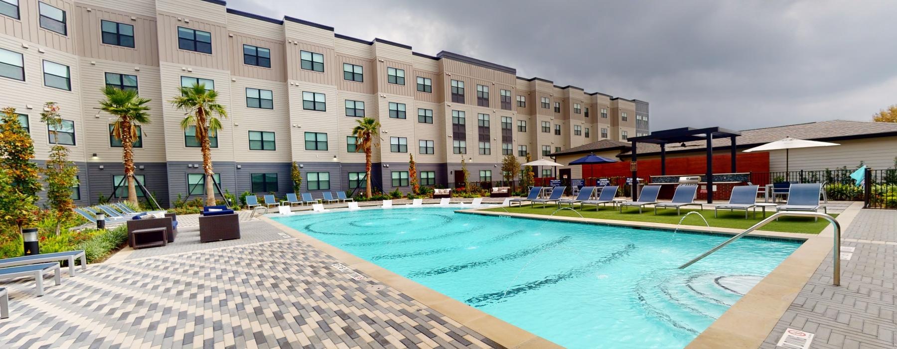 a large building with a pool in front of it