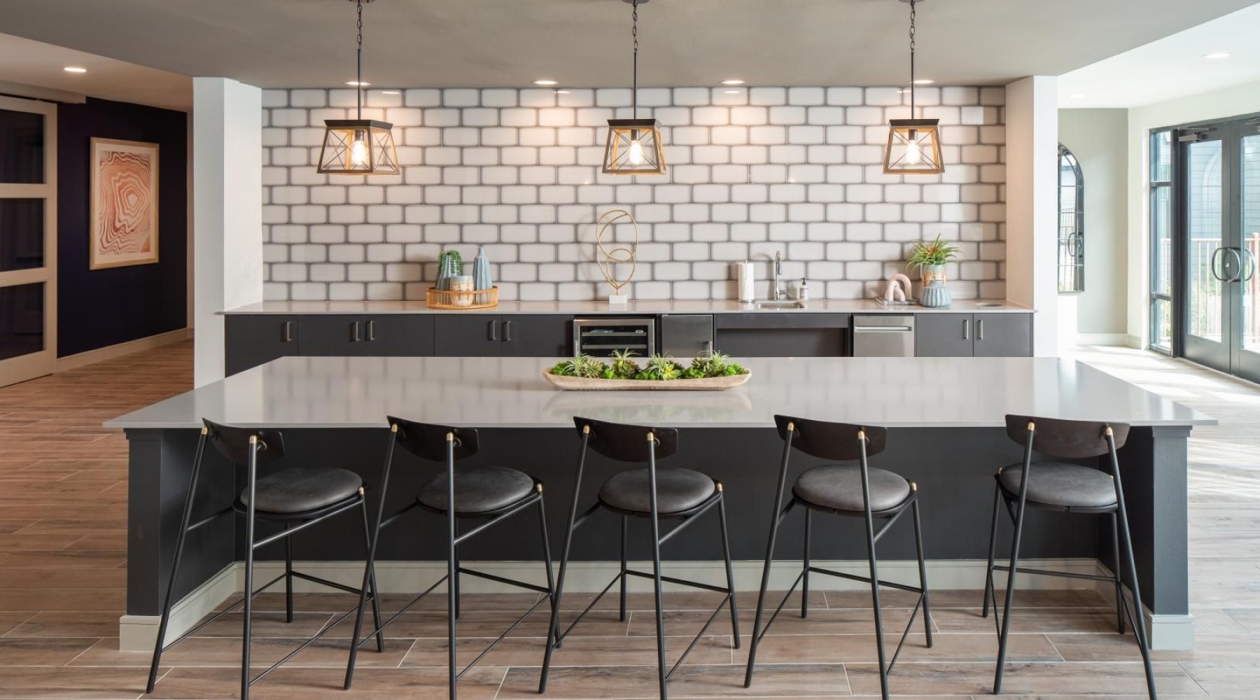 a kitchen with a bar and stools