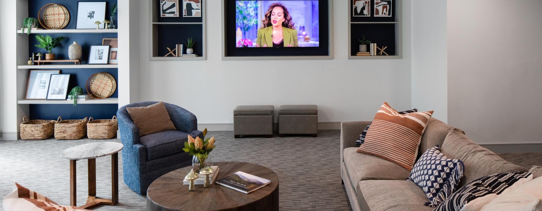 a lounge room with a tv and couches