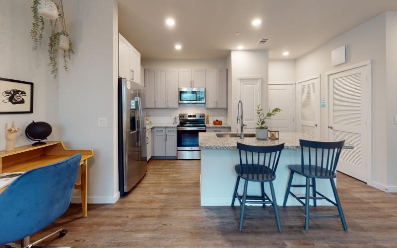 a kitchen island with barstools