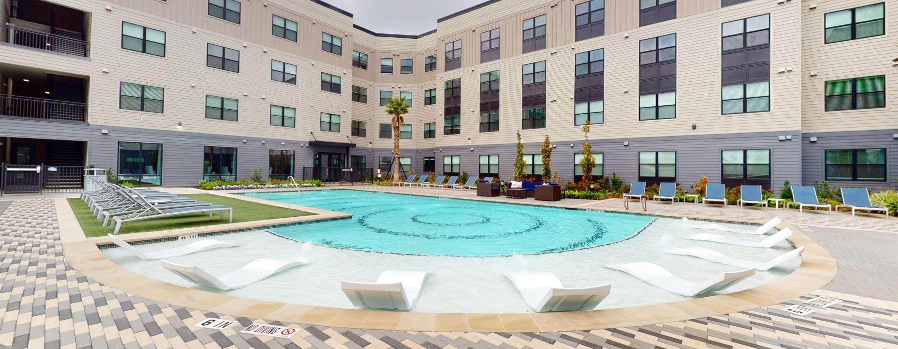 a swimming pool in front of a building
